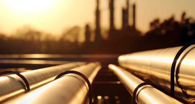 golden sunset in crude oil refinery with pipeline system